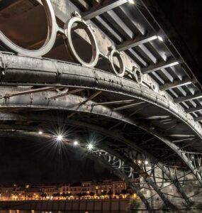 Imagen nocturna del Puente de Triana antes del amanecer, visto desde la orilla izquiera del Guadalquivir