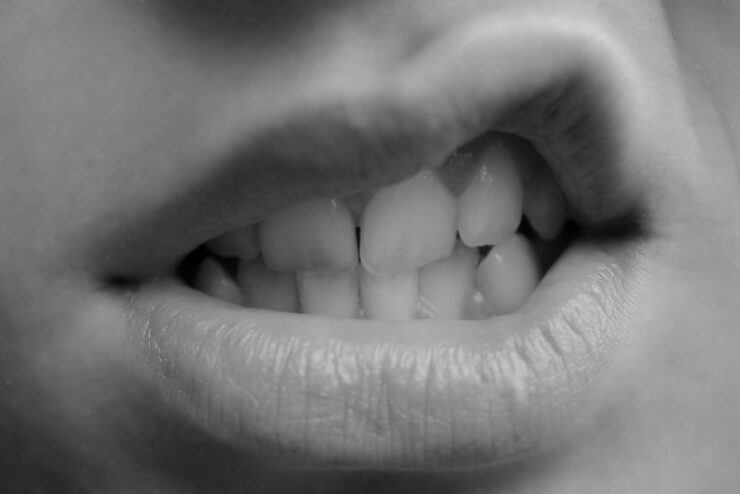 Hermosos labios femeninos que se abren en una expresión de desprecio y agresividad, foto en blanco y negro, para el perfil de Desdimenea